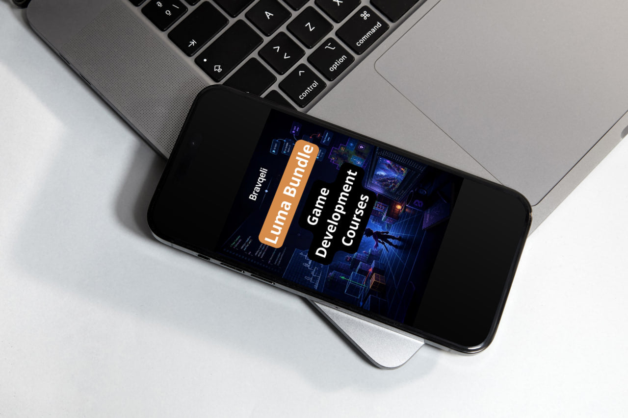 Smartphone displaying a game development course bundle on a laptop