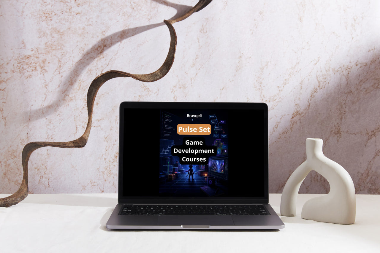 Laptop displaying a game development course on a decorative surface with a marble wall background